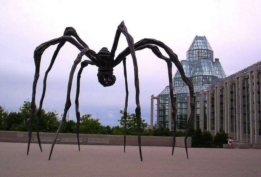 A massive bronze spider sculpture titled "Maman" by Louise Bourgeois, located outside the National Gallery of Canada. 