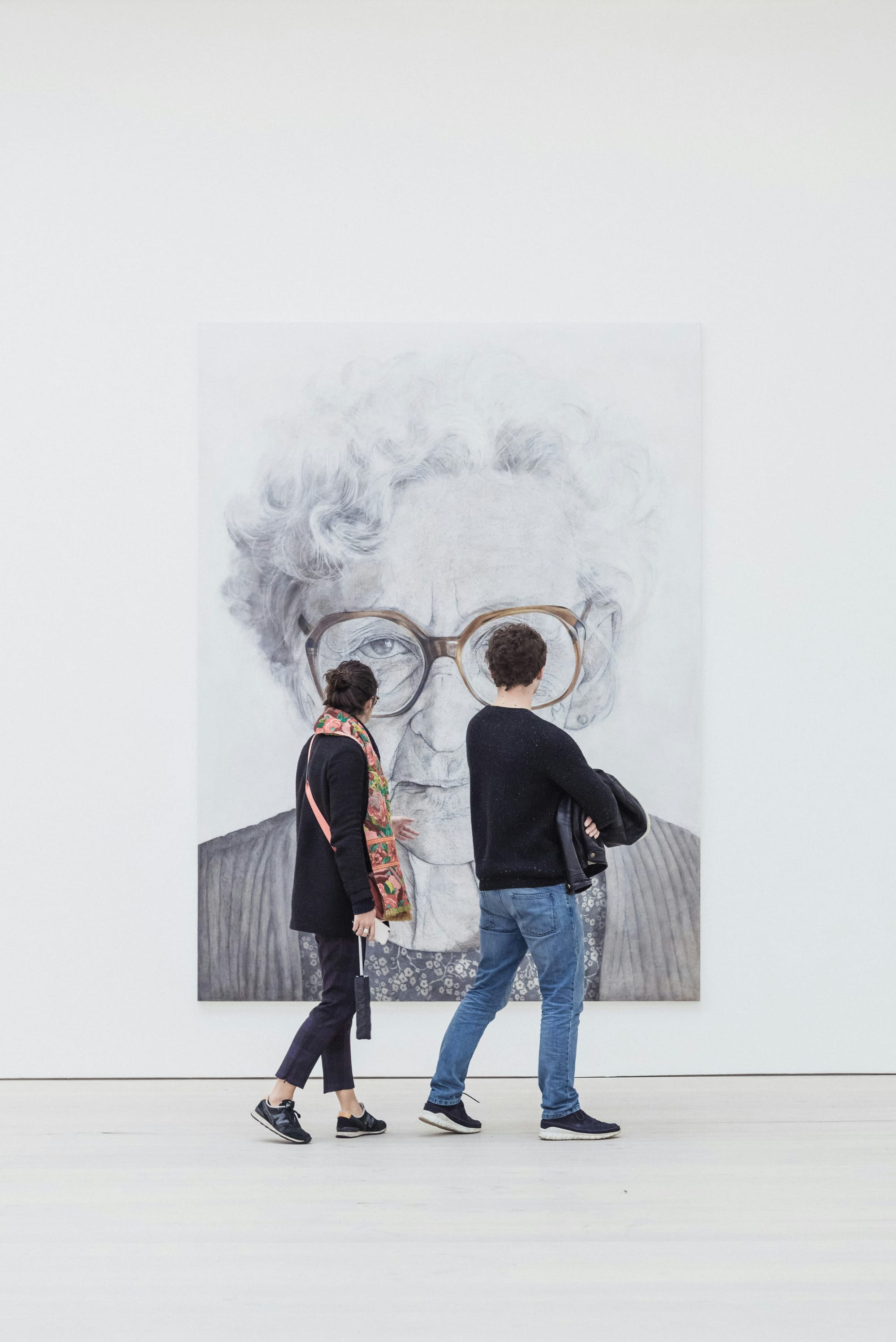 Close-up of gallery visitors viewing an artwork, representing the varied interpretations of art by different audiences.