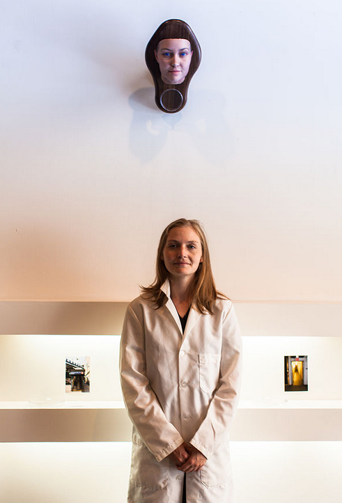 Heather Dewey-Hagborg, the artist, poses in front of her self-portrait.