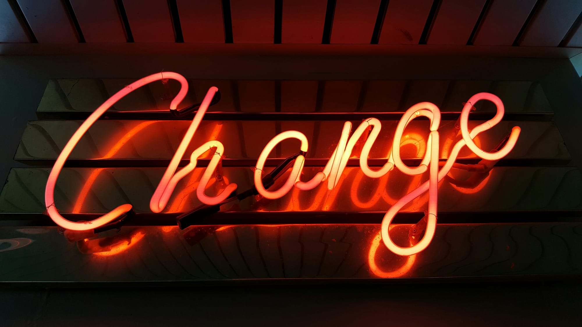 The word "Change" depicted as an artistic centerpiece between discussions of art as self-expression.