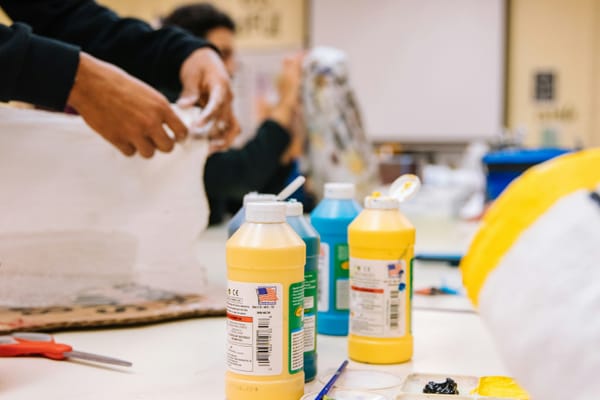 Group of people participating in a painting class.