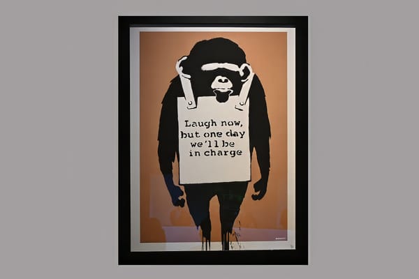 Banksy artwork ‘Laugh Now’ showing a monkey with a sign around its neck reading ‘laugh now, but one day we’ll be in charge’
